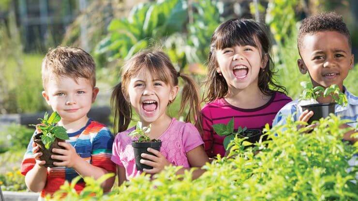 happy kids holding plants